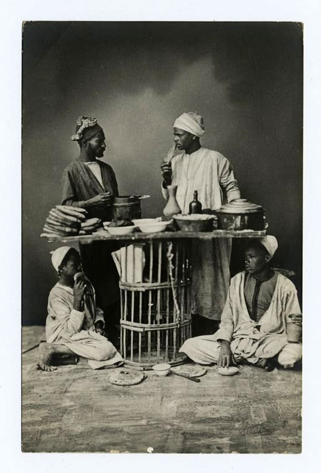 Four men and a table of food