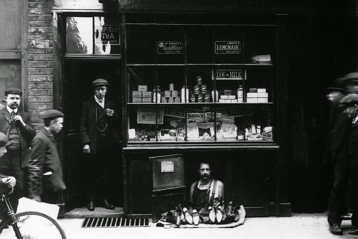 The smallest shop in London at 4 Bateman Street, Soho. The shop, occupied by a cobbler, is six feet long, five feet high and two feet deep. The rent is three pounds a week, 1910