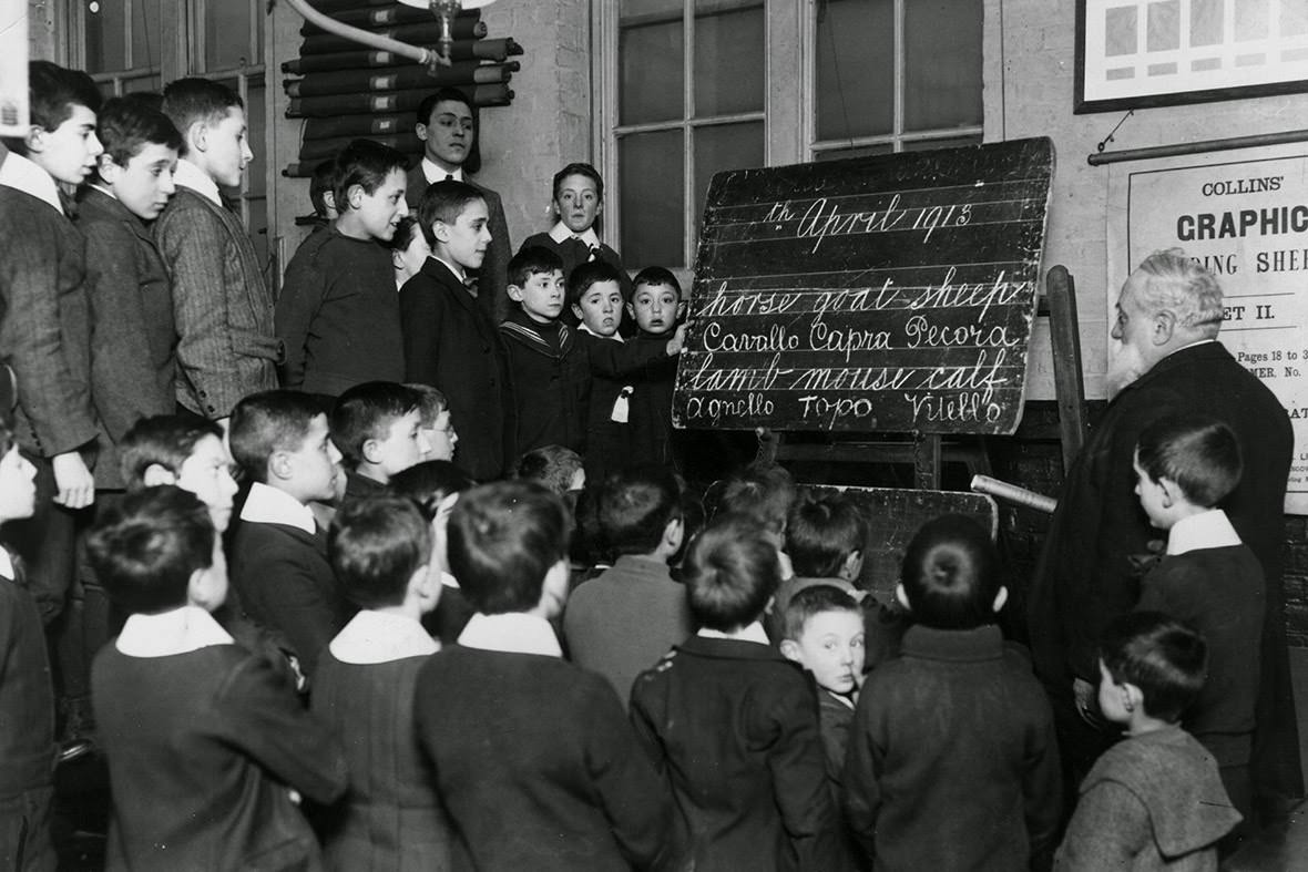English lessons for Italian children at a school in Soho. Signor de Villa instructs boys in reading and spelling, 1913