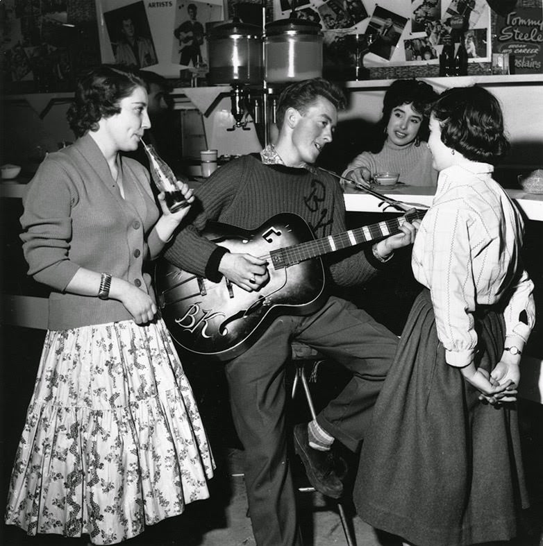 Singer and guitarist Bill Kent entertains some teenage fans in The Two I's Coffee Bar on Old Compton Street in Soho, 1958