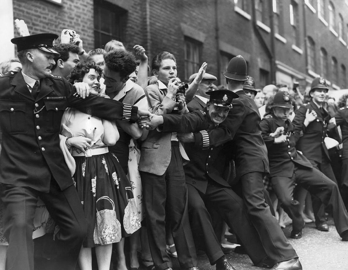 Policemen try to control fans of the rock and roll singer, Tommy Steele, outside Saint Patrick's Church on Soho Square, where he is to be married to Ann Donoghue, 1960