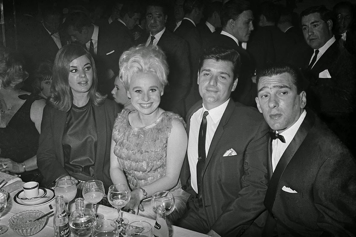 Actress Barbara Windsor and her husband Ronnie Knight sit with Reggie Kray and his wife Frances Shea at the El Morocco nightclub in Soho, owned by the Kray Twins, 1965