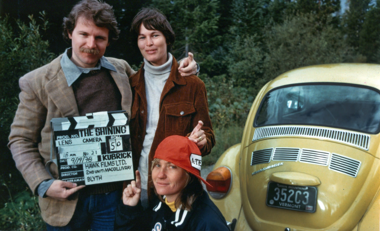 2nd Unit camera operator Jeff Blyth, Jeff’s wife, and their camera assistant doubling for the Torrance family in many unused shots of the car and wearing costumes from the film. Note their “Tony” finger poses.