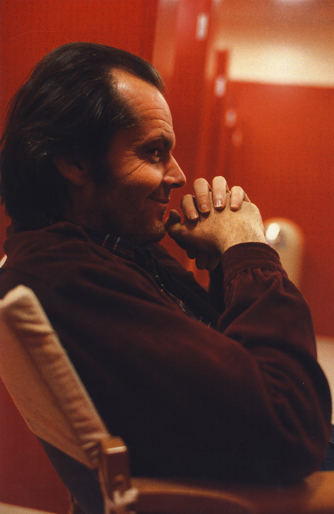 Jack Nicholson, (in reflection) Stanley Kubrick and daughter, Vivian, on set.