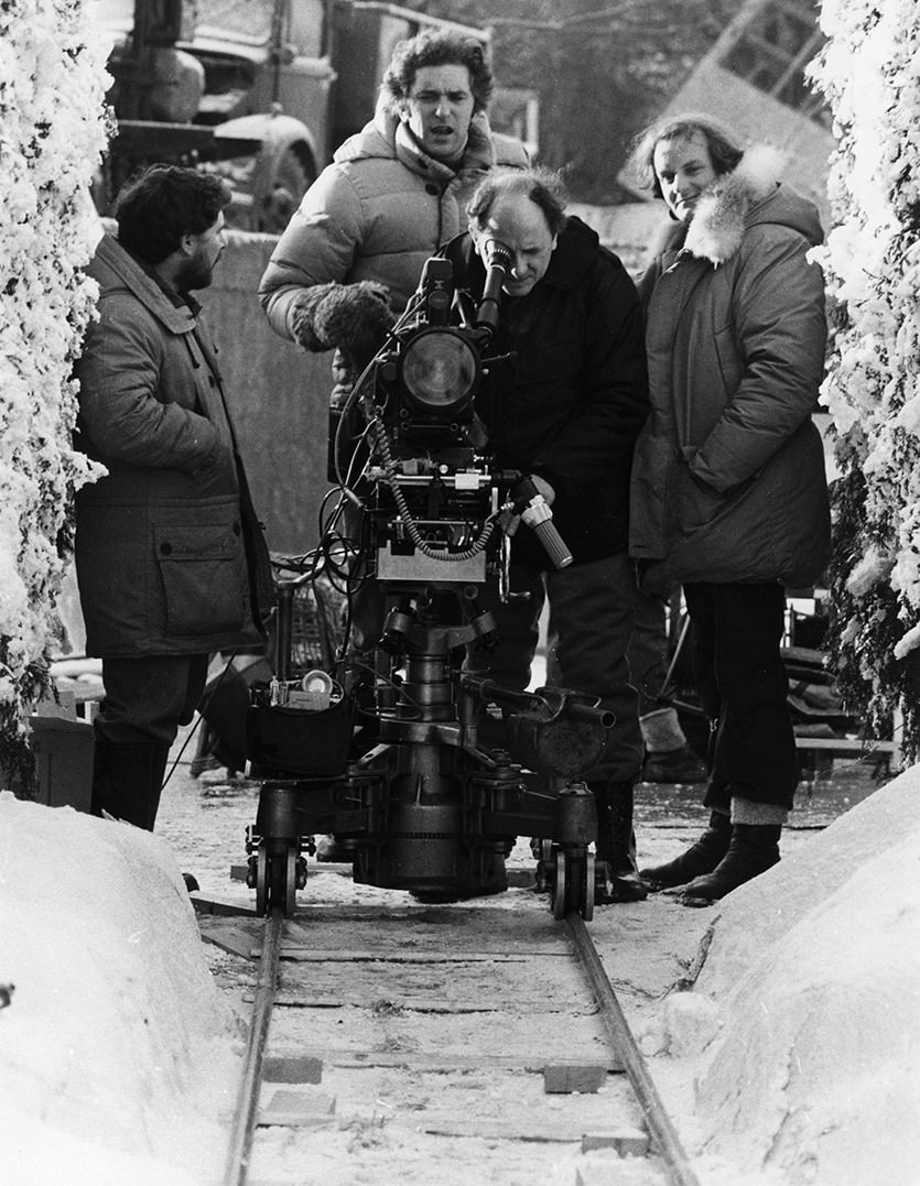 Grip Dennis Lewis, Assistant Director Brian Cook, Camera Operator Kelvin Pike, and Camera Assistant Douglas Milsome set up a shot for in the exterior hedge maze set on the backlot of Elstree Studios.