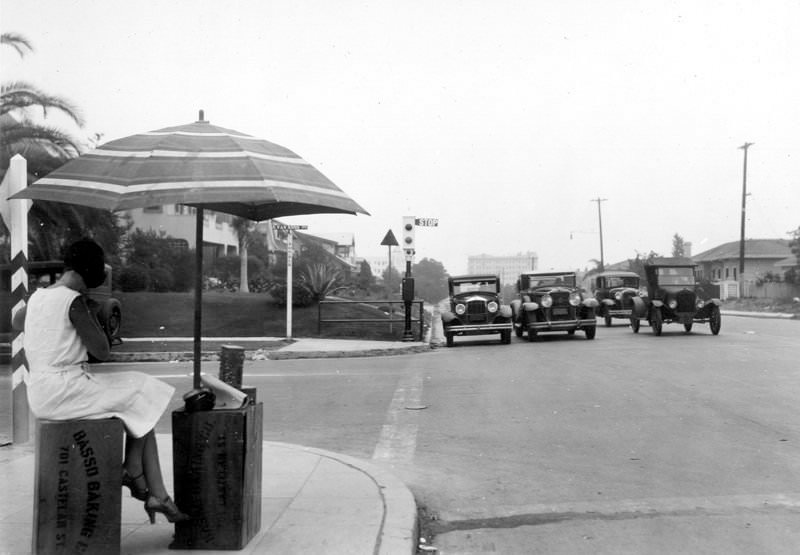 Girl waiting for bus on Beverly Boulevard, interesection at Van Ness, July 17, 1931