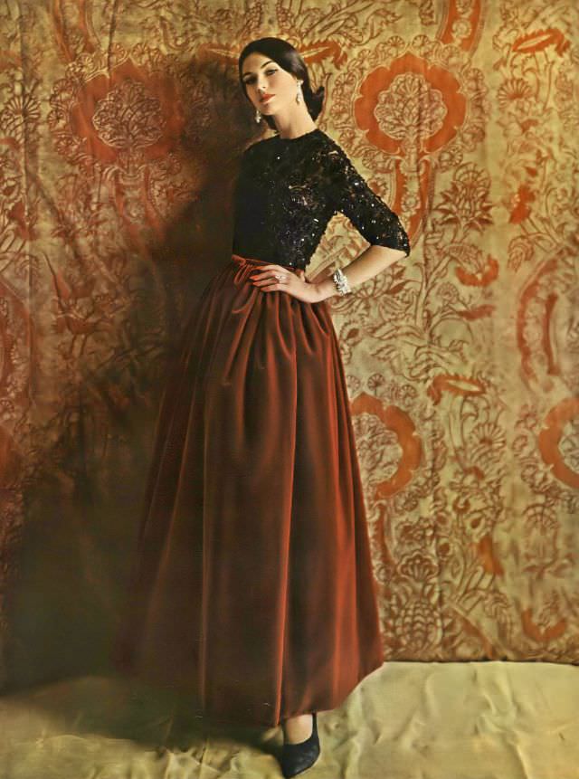 Model in evening dress of jet-spangled lace and burgundy velvet by Samuel Winston, diamond jewelry by Harry Winston, opera pumps by Andrew Geller, October 1, 1960