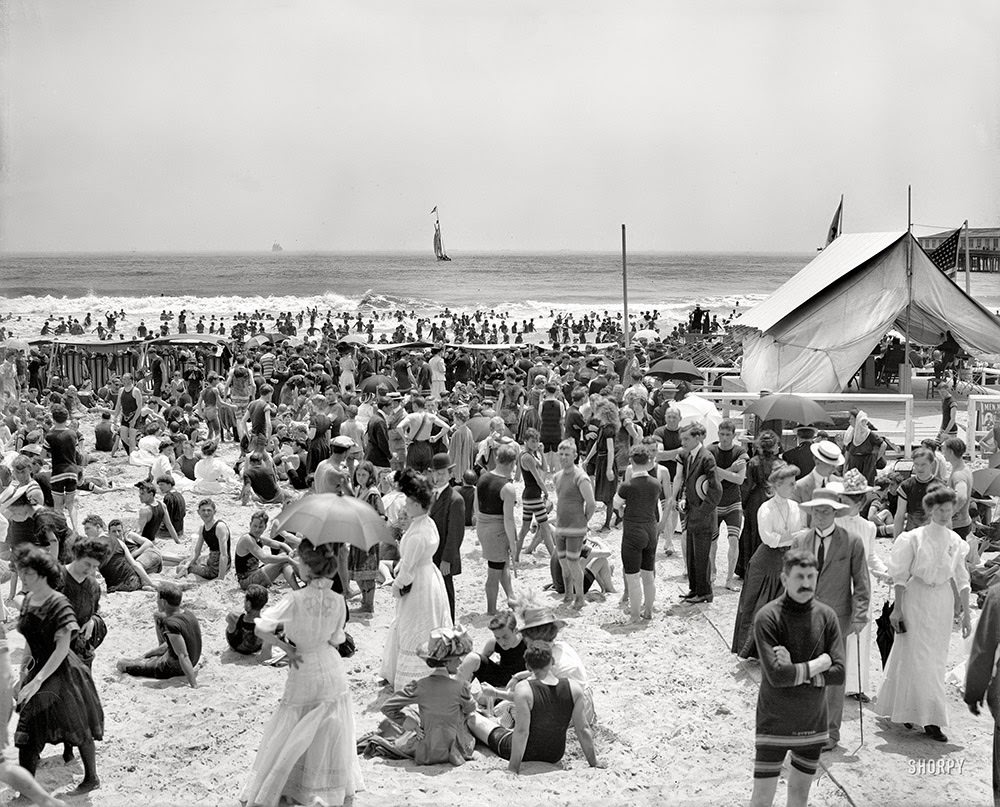 Circa 1910. Atlantic City, N.J. -- the bathing hour. Nattily attired in a variety of suits.