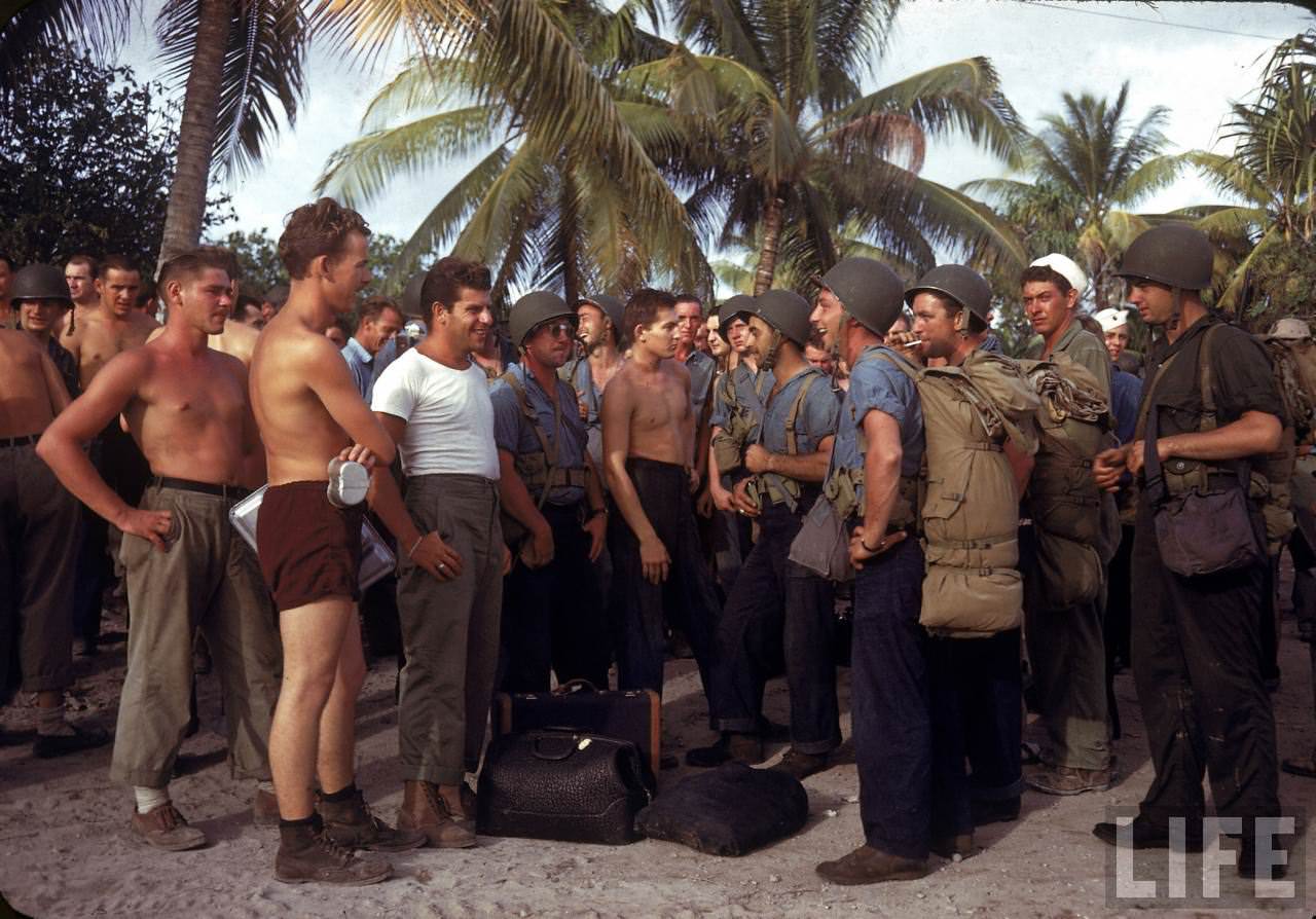 Two groups of American servicemen chatting on Tarawa during WWII.