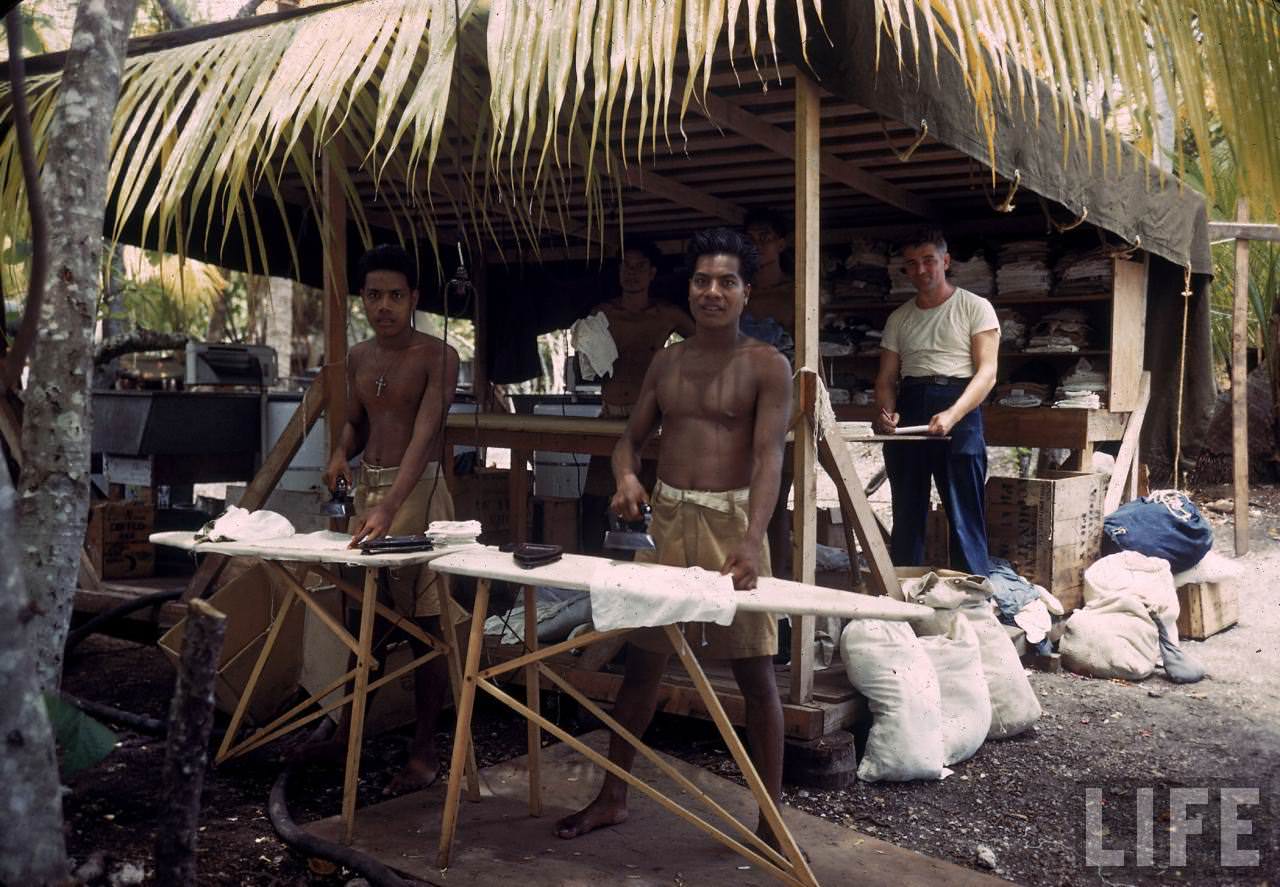 Native men ironing GI clothes on Tarawa during WWII.