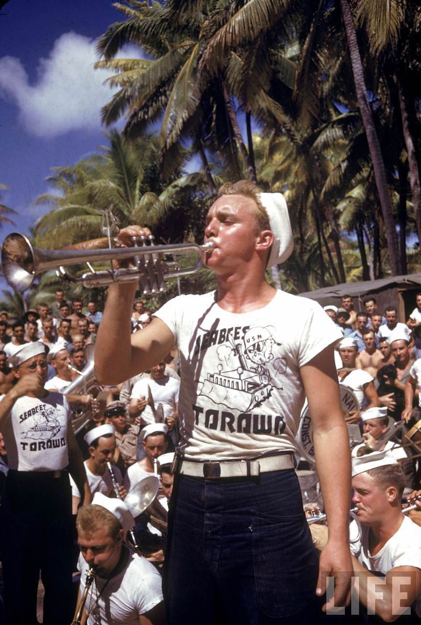 Trumpet playing Nvay seabee taking part in an impromptu concert for the troops stationed on the island during WWII.