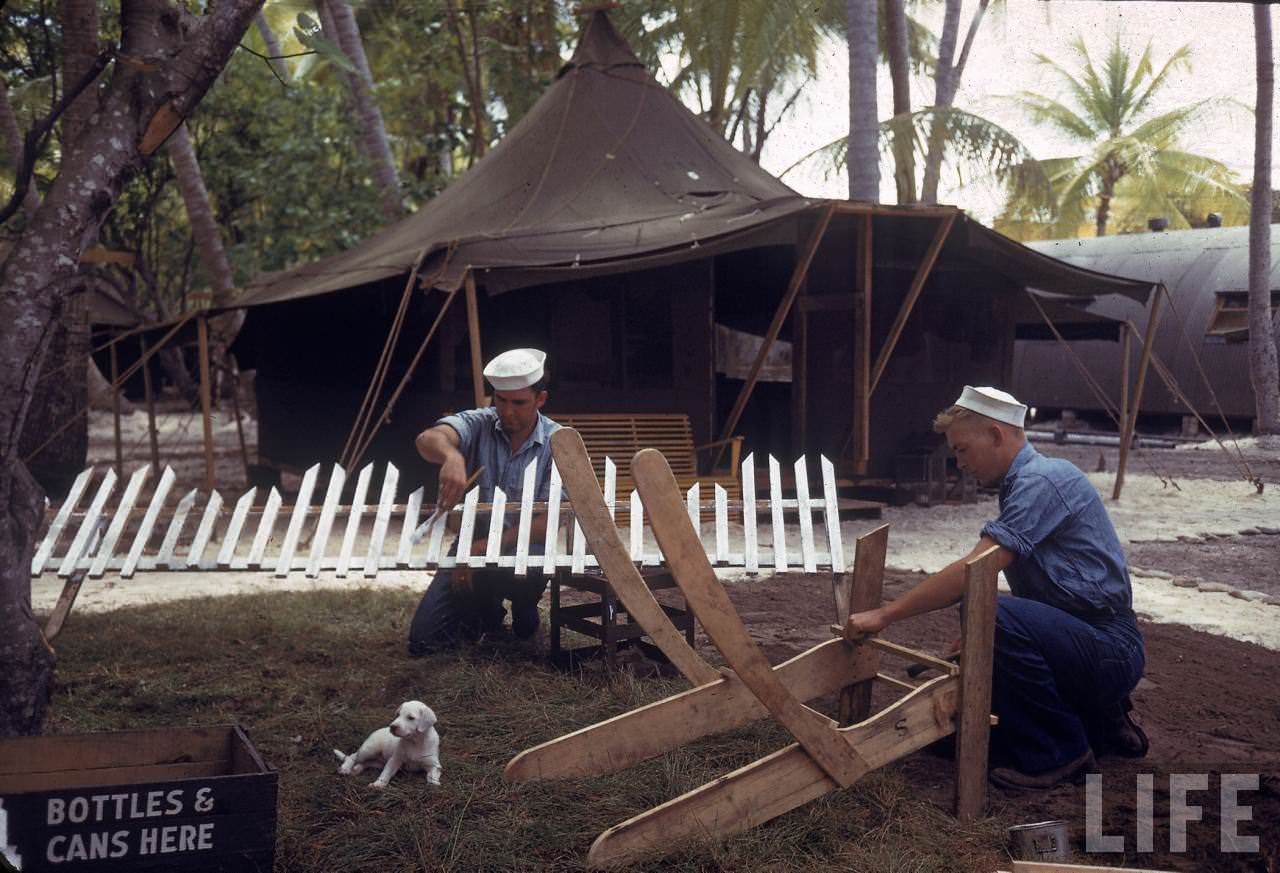 American sailors building furniture and a white picket fence on Tarawa during WWII.