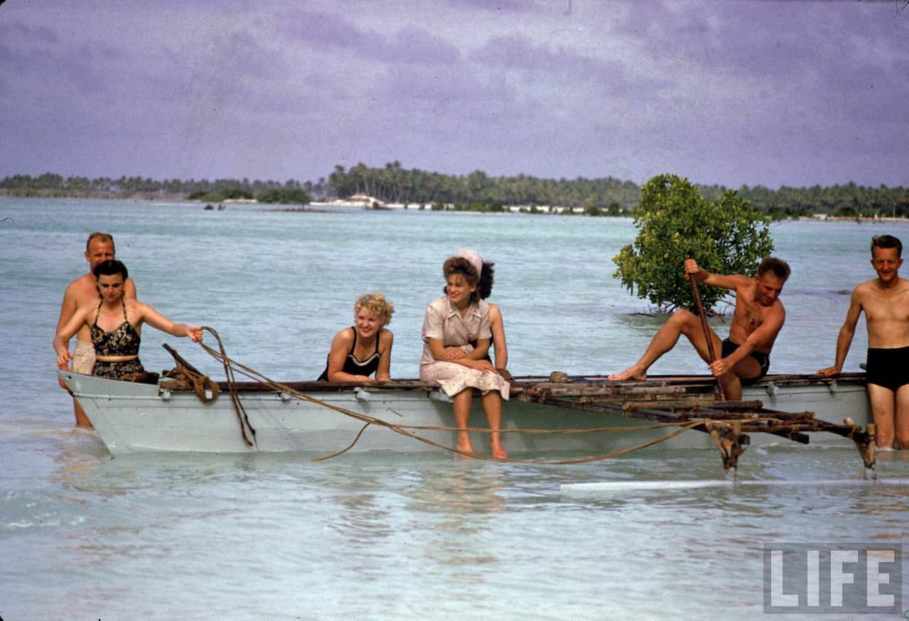 American servicemen and women relaxing on a boat ride along the shores of the Tarawa Atoll during WWII.