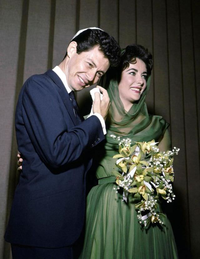 Elizabeth Taylor chose a green silk hooded dress for her wedding to Eddie Fisher, on May 12 1959 in Vegas