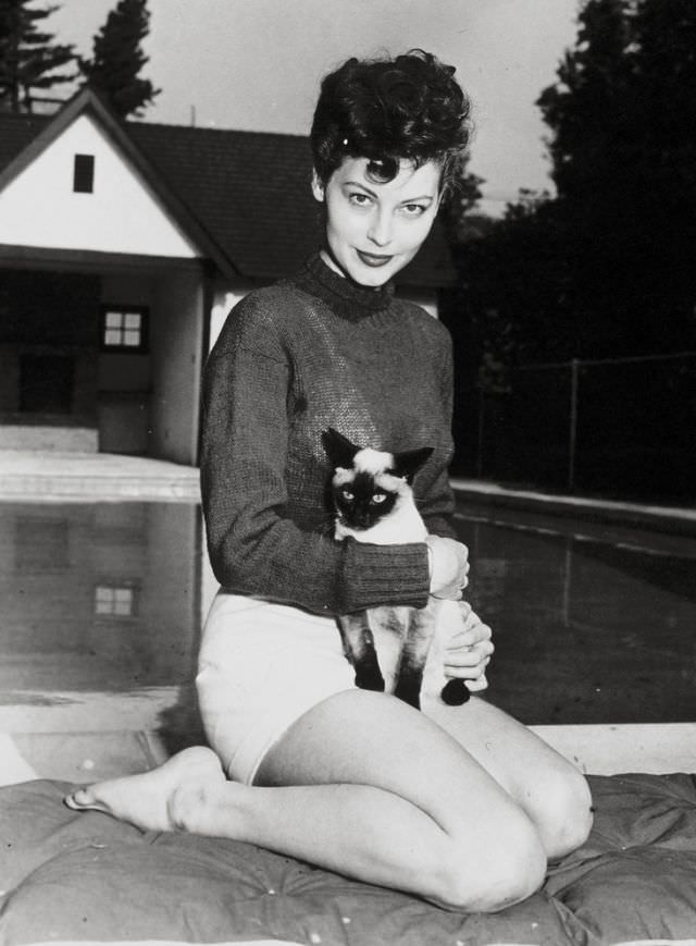 Ava Gardner holding her Siamese cat, 1946