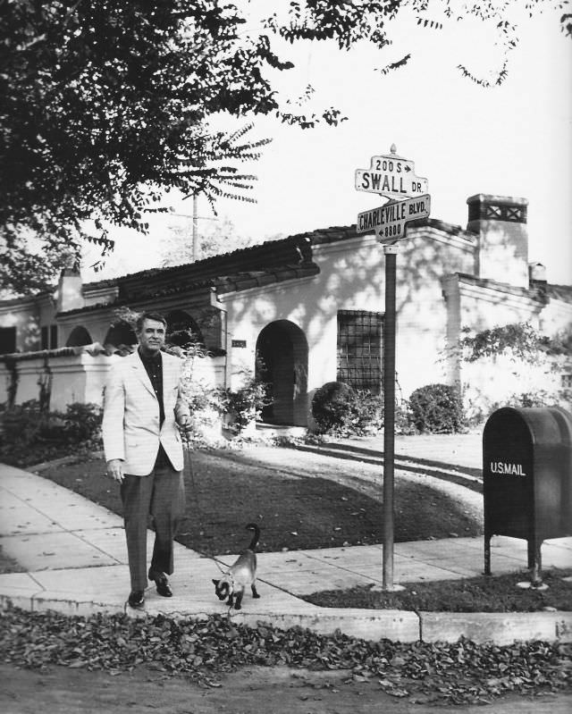 Cary Grant walking his Siamese cat in Beverly Hills, 1955