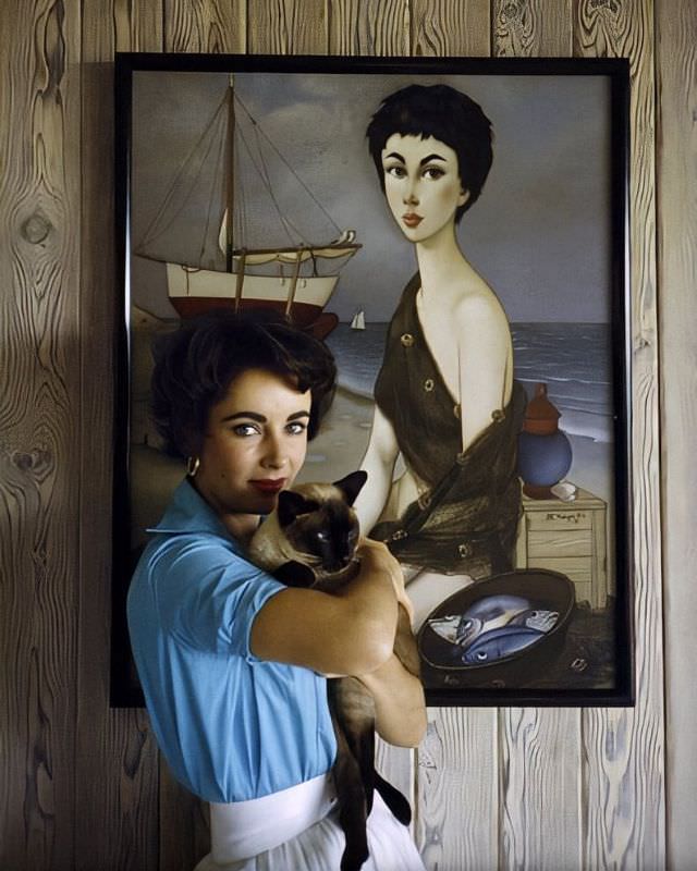 Elizabeth Taylor at her Beverly Hills home with her pet Siamese cat, 'Coffee,' 1956