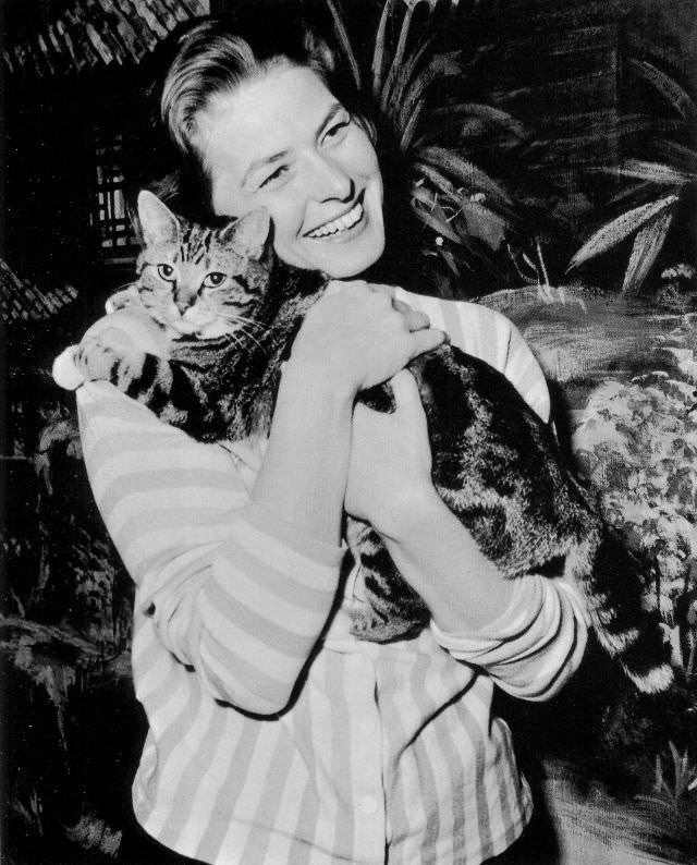 Ingrid Bergman hugging cat while on filming set at Elstree, England, 1958