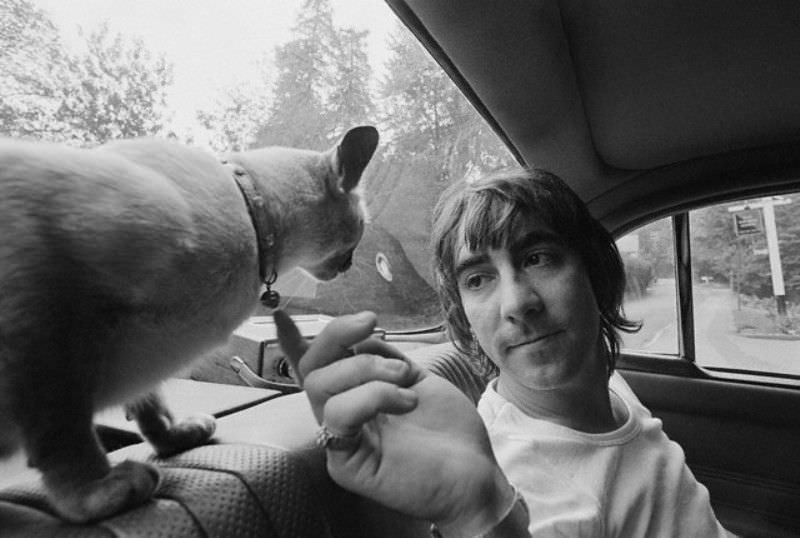 The Who's drummer Keith Moon riding in the backseat with his cat, 1970