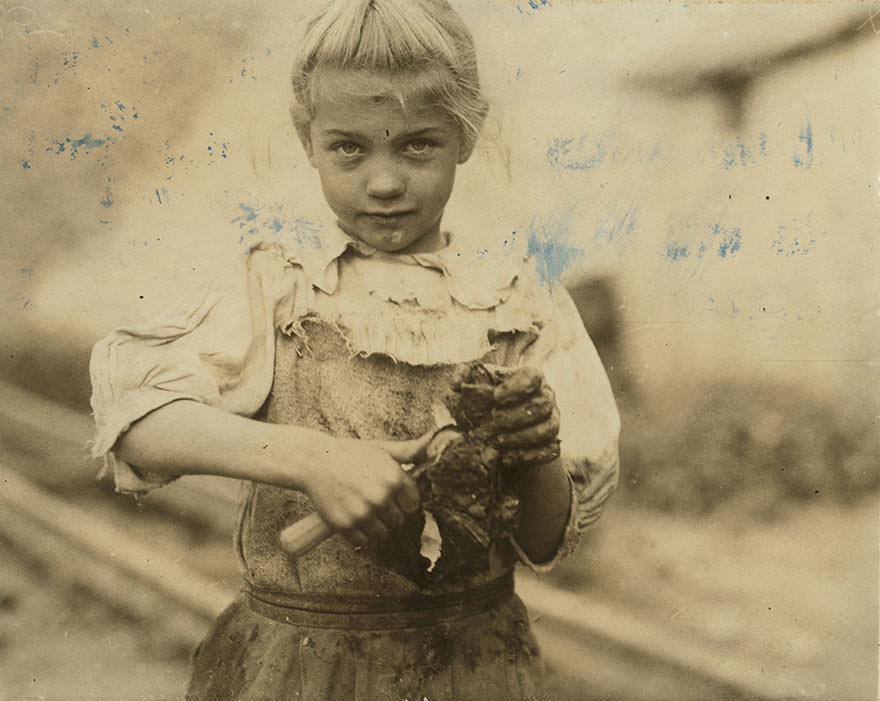 Seven-year-old Rosie. Regular oyster shucker. Her second year at it. Illiterate. Works all day. Shucks only a few pots a day. Varn & plat canning co. Location: Bluffton, South Carolina