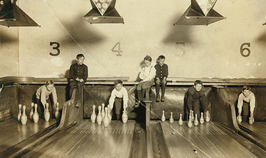 Photo of boys working in arcade bowling alley, Trenton, n.j. Photo taken late at night. The boys work until midnight and later. Location: Trenton, new jersey