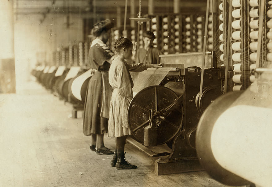 Girls running warping machines in loray mill, Gastonia, n.c. Many boys and girls much younger. Location: Gastonia, North Carolina