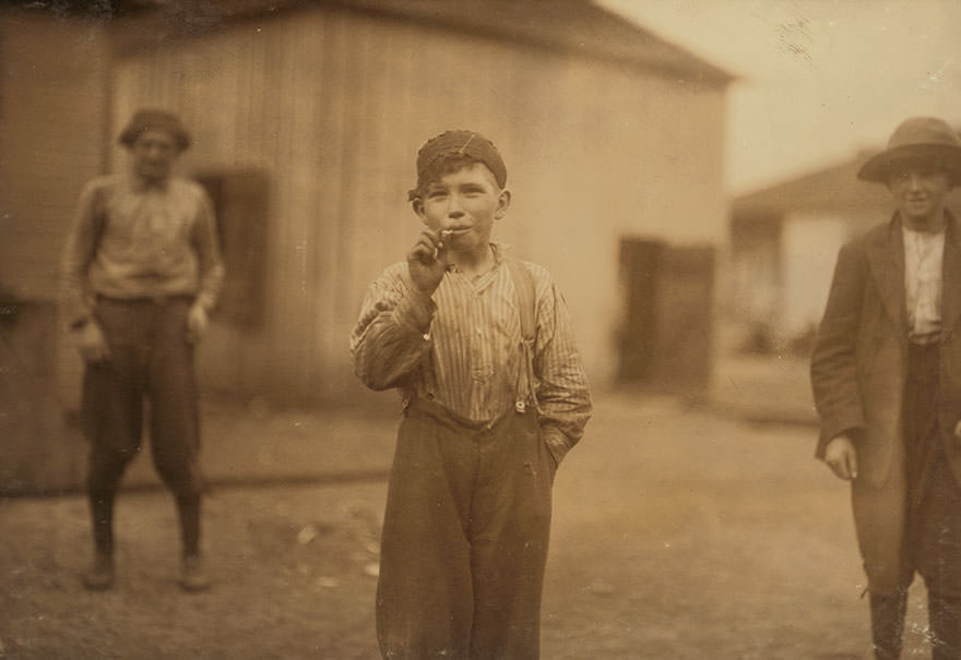 John Tidwell, a cotton mill product. Doffer in Avondale mills. Many of these youngster’s smoke. Location: Birmingham, Alabama
