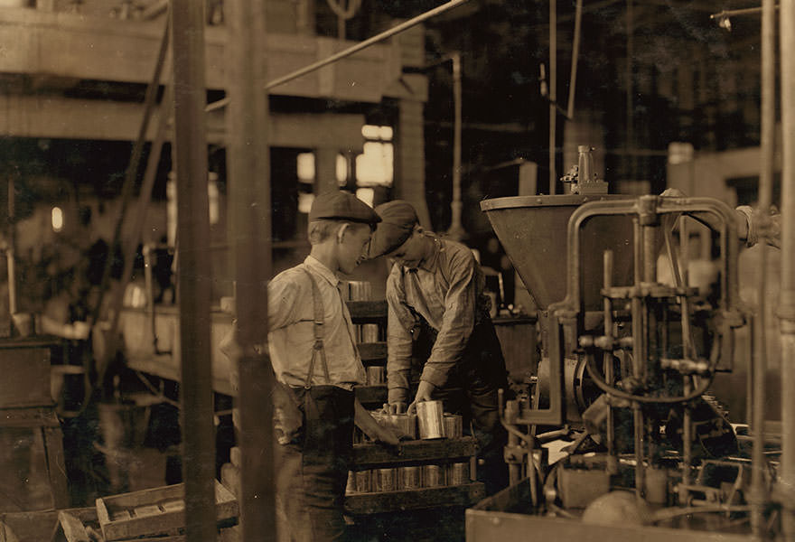 Small boys work at and around these machines some of which are dangerous. Location: Baltimore, Maryland