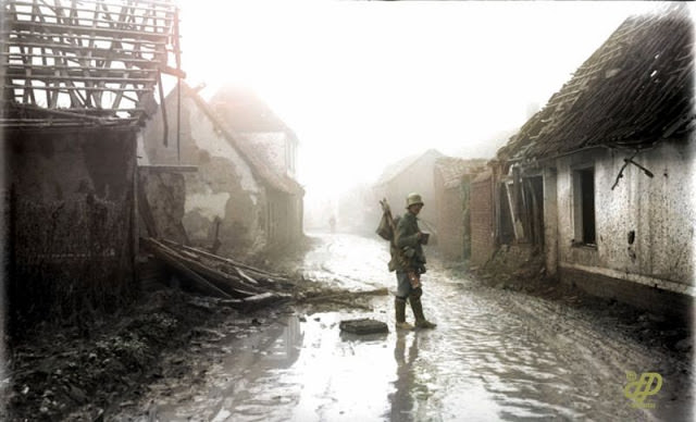 German infantryman in the middle of the damaged or destroyed buildings of the village, Etricourt, France