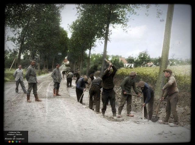 German soldiers supervising Belgian civilians employees road repair, Belgium, 1916