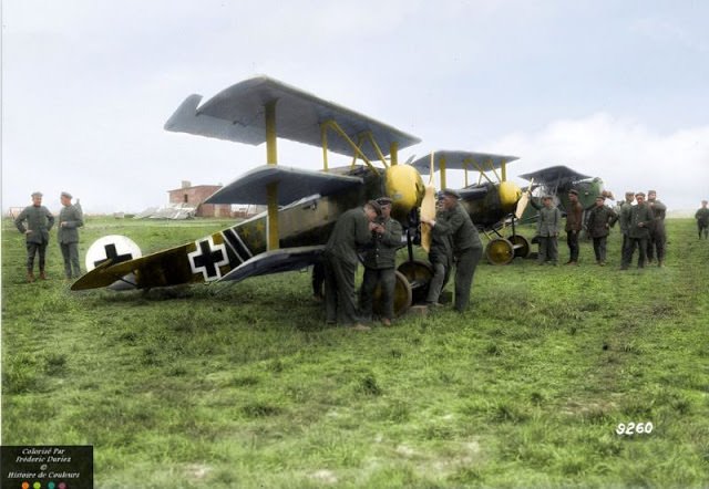 Two Fokker Dr.Is marked with the yellow cowlings and tails of Royal Prussian Jasta 27 are readied for takeoff at Halluin-Ost aerodrome in May 1918