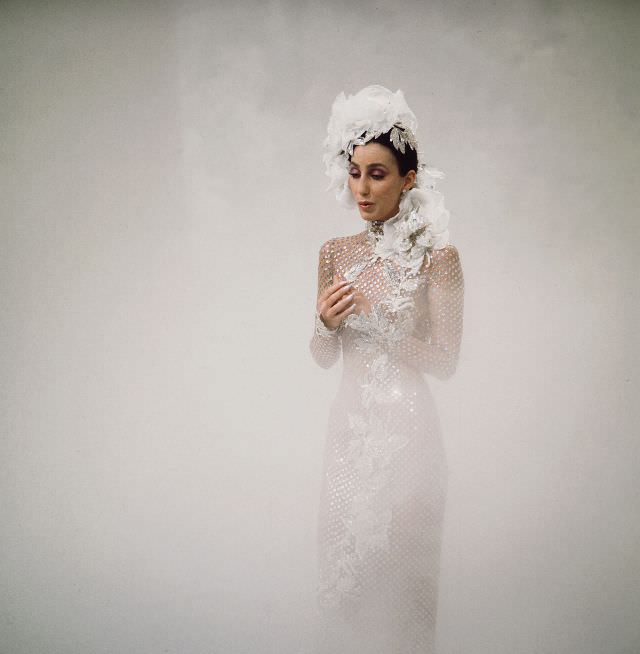 Promotional portrait of Cher as she sings from a cloud of fog for the television variety show 'The Sonny and Cher Comedy Hour, 1972