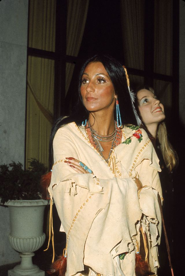 Cher wears beaded jewellery as she stands with arms folded in a Native American Poncho at the premiere of 'Last Tango in Paris.' Photo by Frank Edwards, 1973