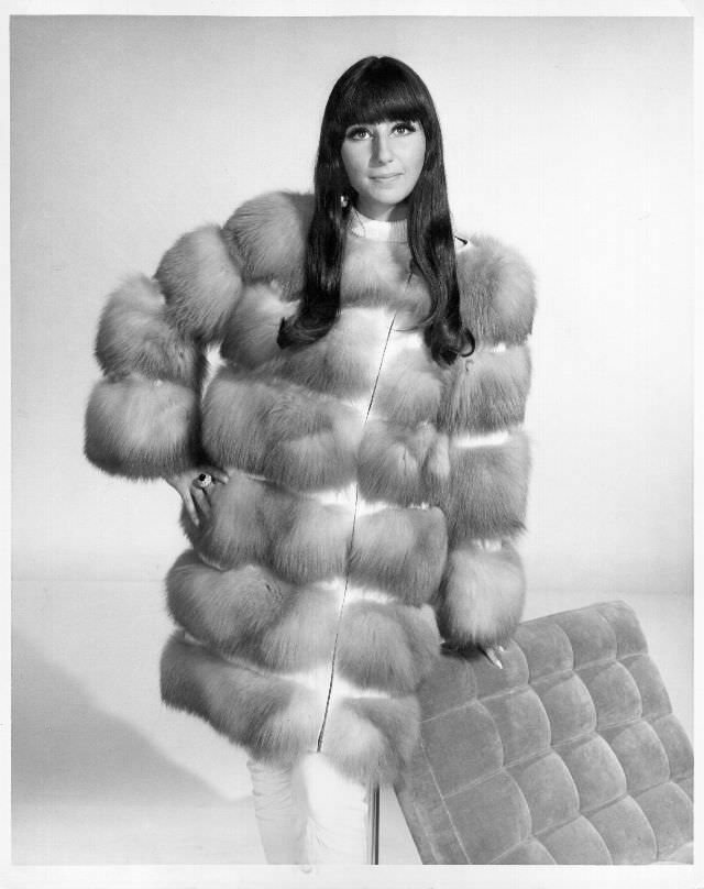 Cher poses for a portrait wearing a fur coat. Photo by Michael Ochs Archives, 1966