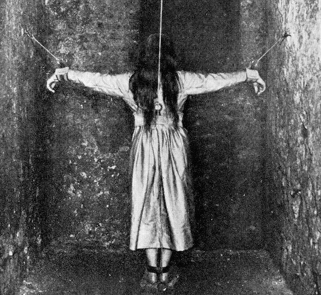 A patient undergoing treatment for mental illness in Germany by being forced into a crucifixion pose, 1890