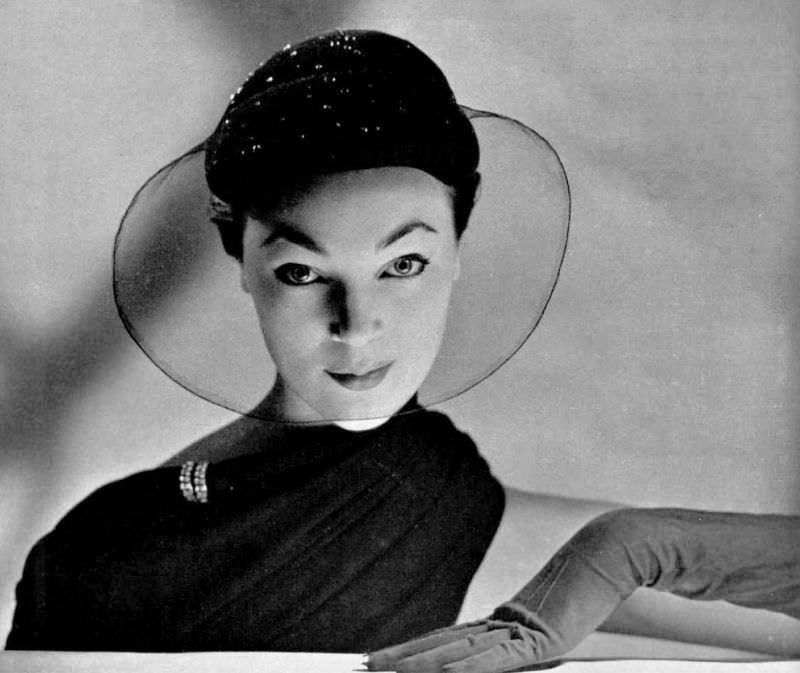 Ivy Nicholson is wearing small velvet cap embroidered with pearls and sheer voilette by Rose Valois, 1951