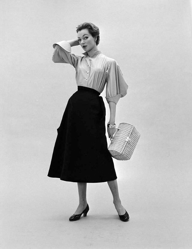 Ivy in Givenchy's skirt and blouse with wide 3/4 sleeves and exaggerated cuffs,February 1952