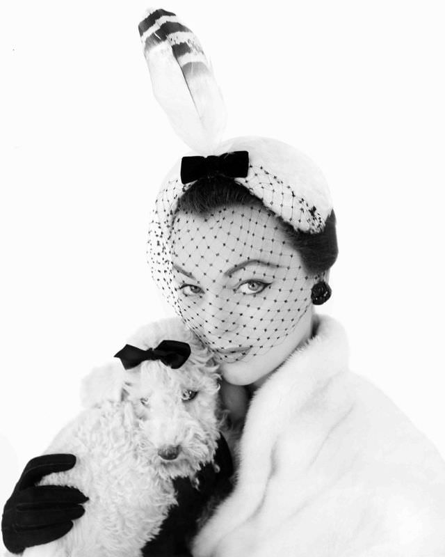 Ivy Nicholson in Albouy's white melusine cap, with black velvet bow, netted veil and feather, 1954