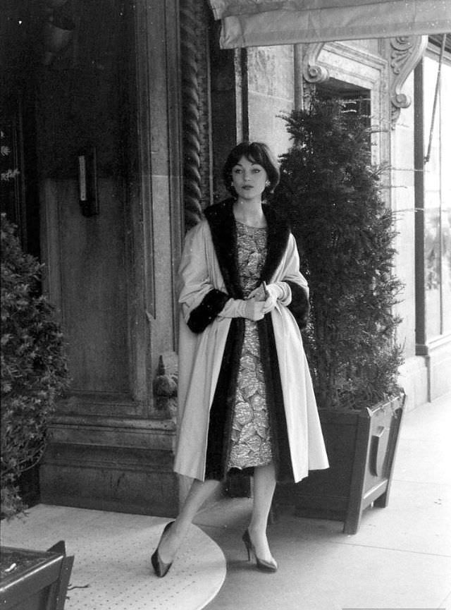 Ivy Nicholson wearing gold brocade sheath worn with a fur-lined evening coat, 1957