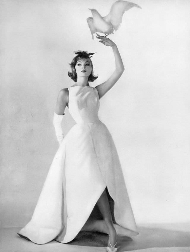 Ivy Nicholson in beautiful evening dress of stiff white cotton ottoman with great petals of skirt that curve up in front and down in back, Harper's Bazaar, March 1958
