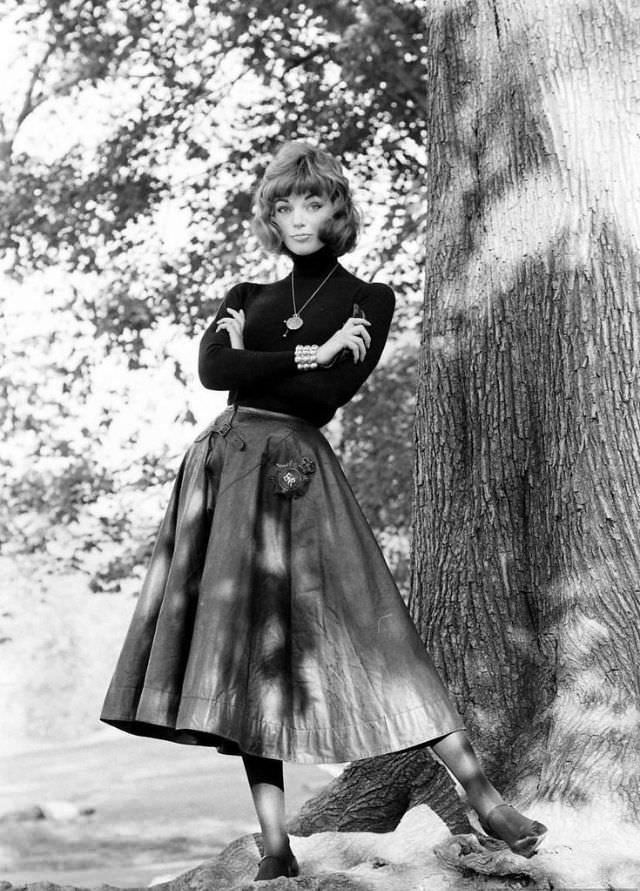 Ivy wears traditional "English bobby" oilskin cape as a skirt, imported by David Seiniger of Empire Imports, 1958