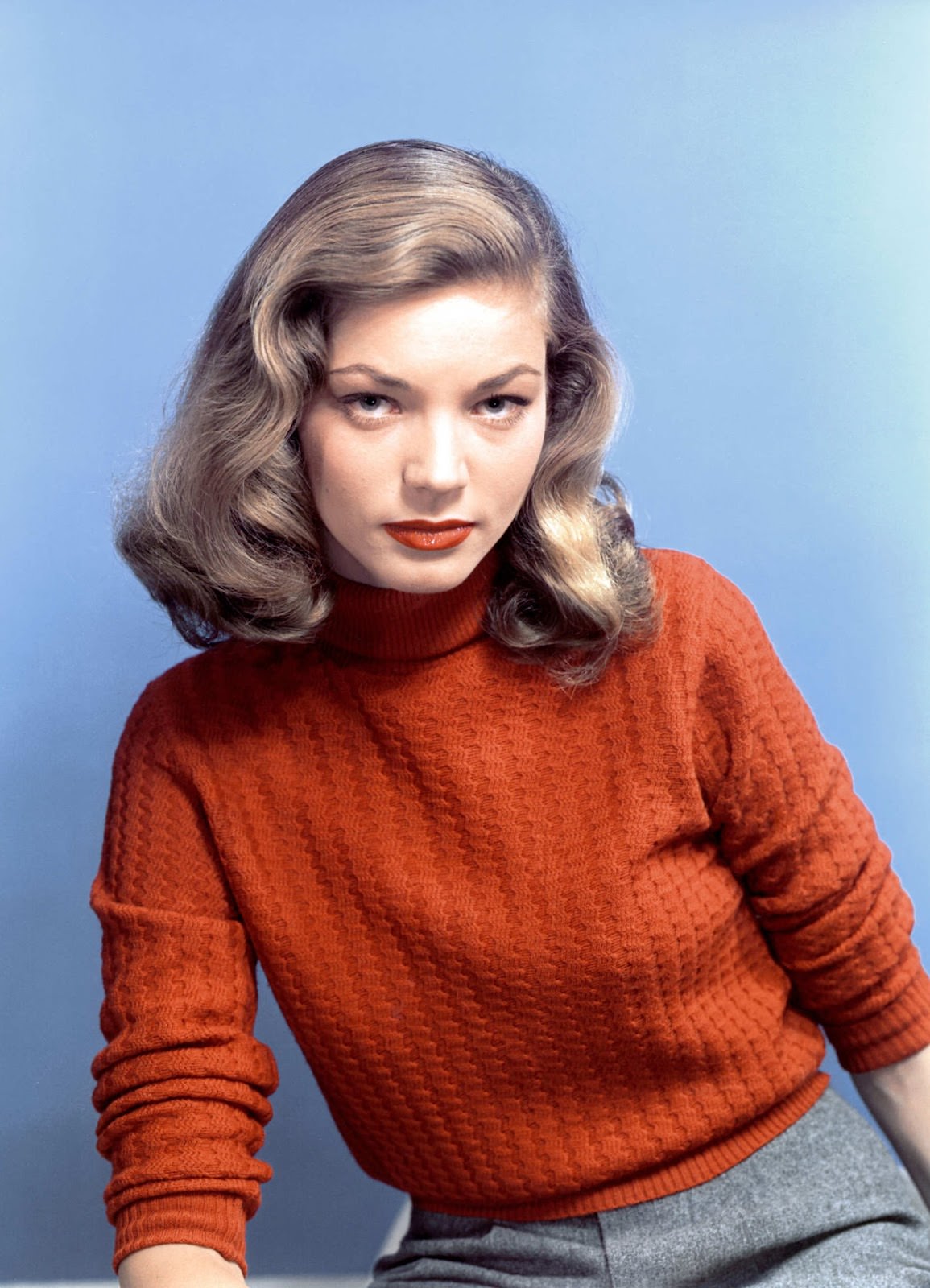 A bold orange turtleneck and a matching bold lip, circa the ’40s.