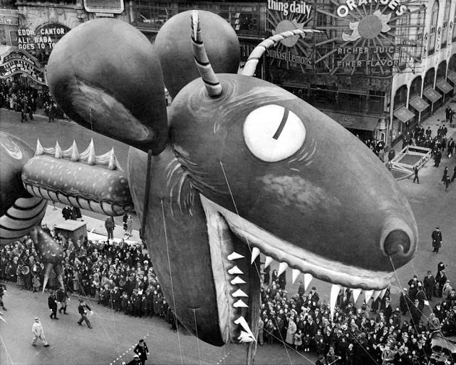 Sea serpent swoops down on crowds watching thirteenth annual Macy's Thanksgiving Day parade on Broadway and 56th St., November 25, 1937.