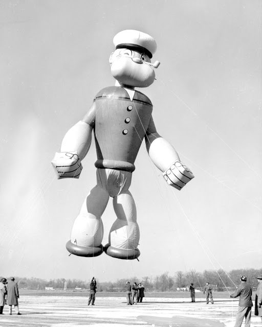 Popeye, the sailor, flexes his muscles as he gets ready to parade in Macy's Thanksgiving Day parade in 1957. Popeye stands 56 feet tall, 32 feet wide and he's filled with 6,000 cubic feet of helium.
