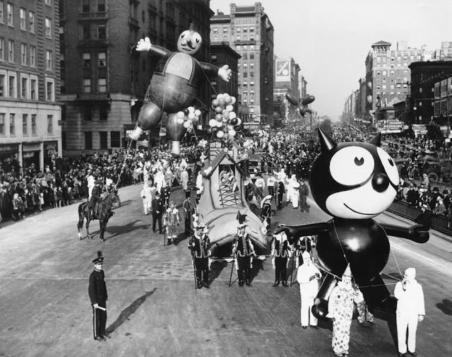 A Felix the Cat balloon and other parade floats and balloons are led down Broadway during the annual Macy's Thanksgiving Day Parade in 1930.