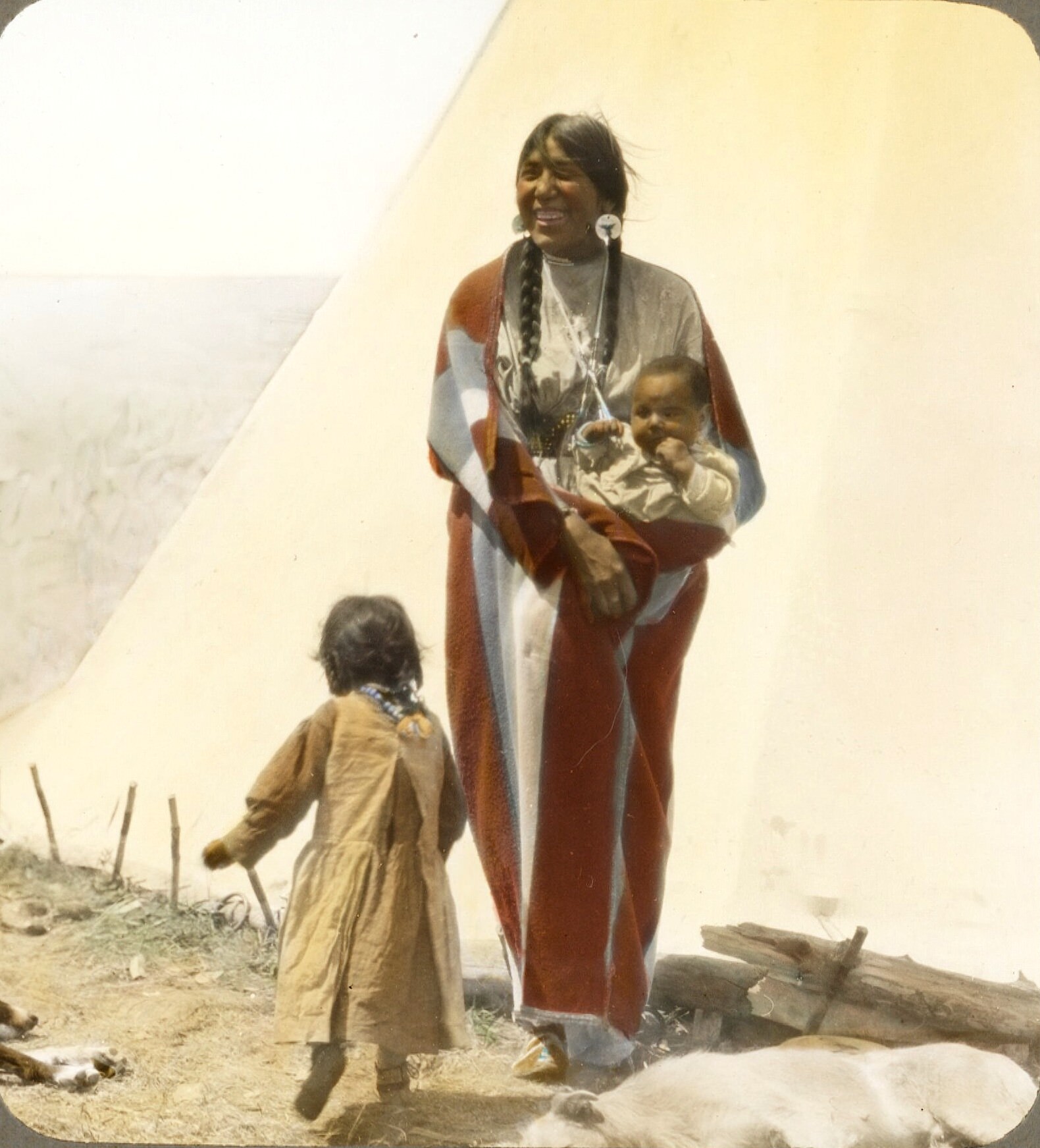 "Coming Running". Blackfeet woman with children. Montana. Early 1900s. Glass lantern slide by Walter McClintock.