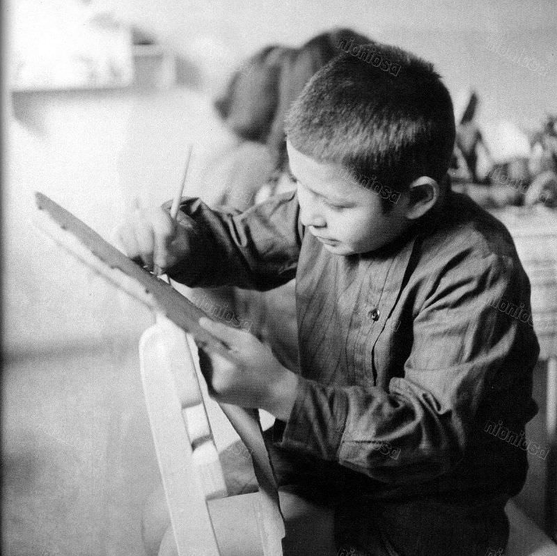 Boy drawing, circa 1905-55