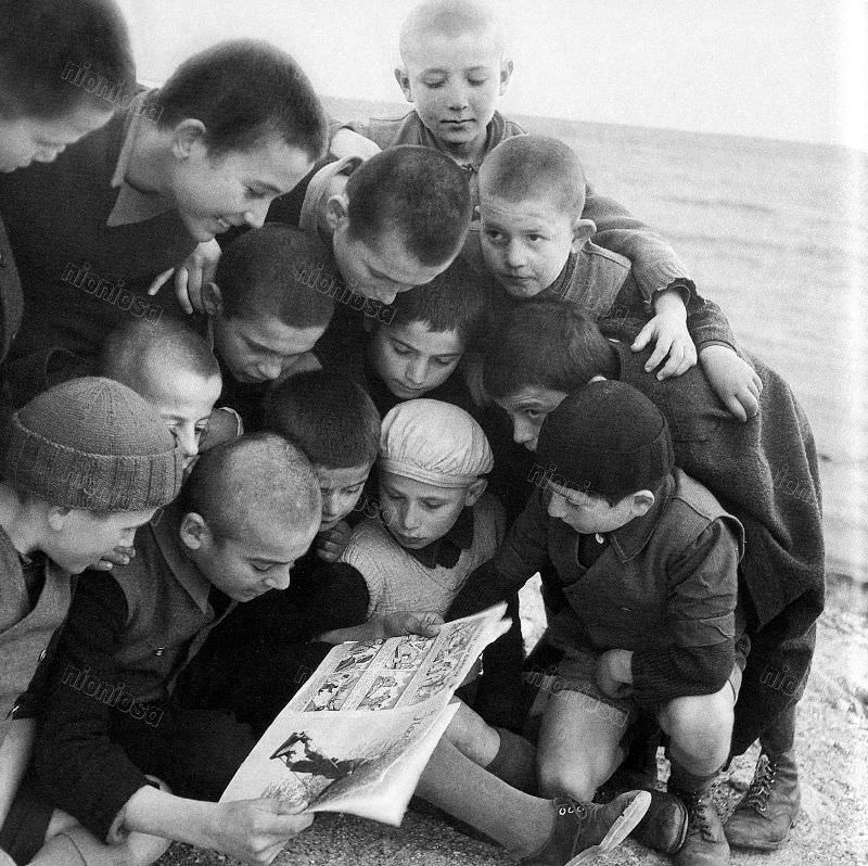 Boys reading a comic book, 1950