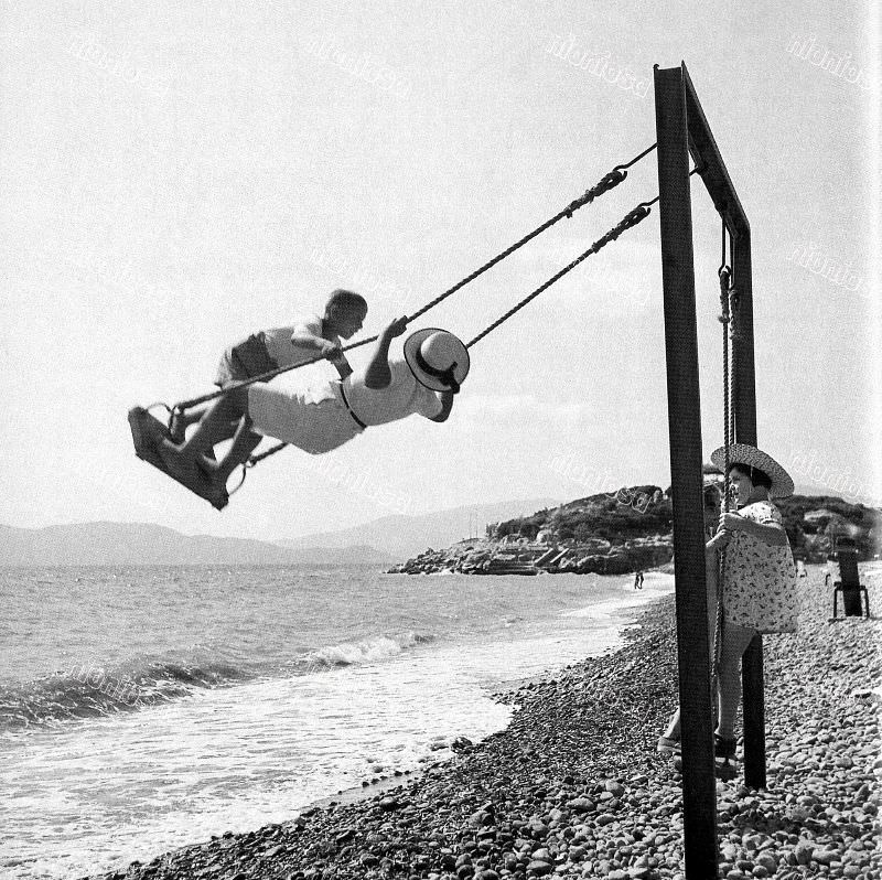 Children swing, circa 1950