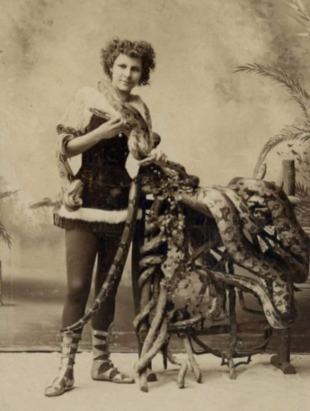 Snake Charmer girl charming snakes and pythings, 1900s